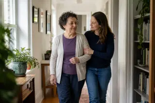 Family member supports a calm woman walking in a bright, cozy apartment hallway filled with gentle natural light.